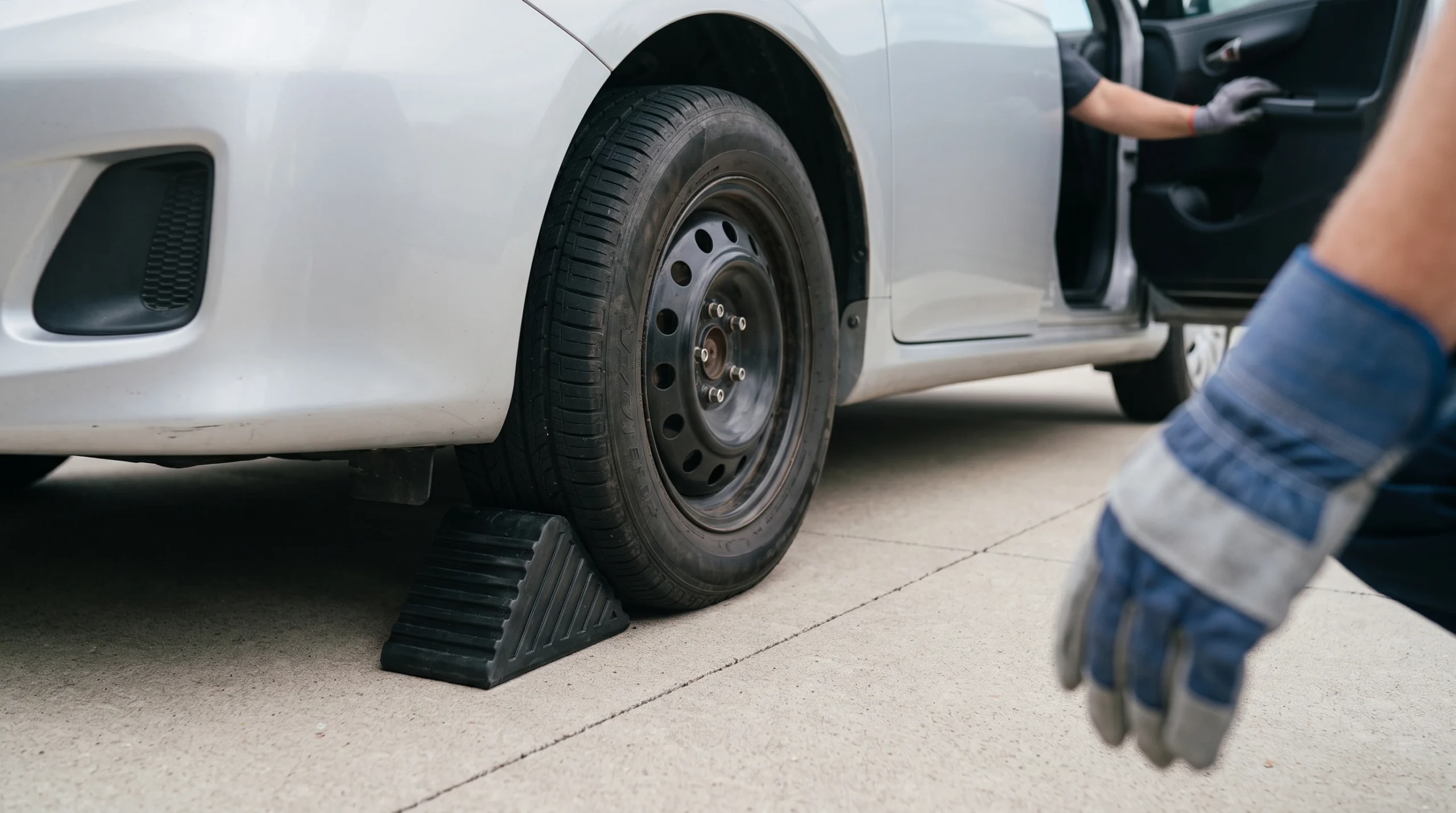 Wheel wedge pushed against a tire so the car cannot roll